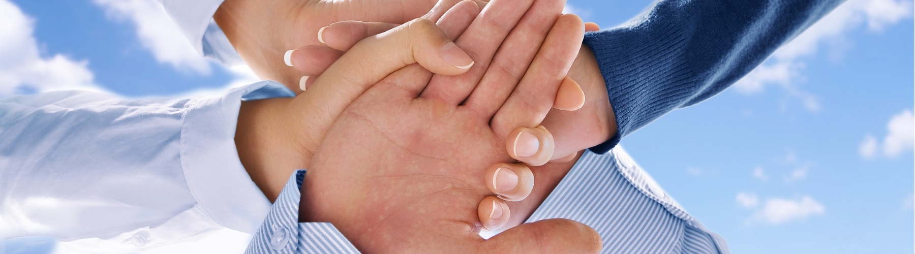 people putting their hands in the center of a circle