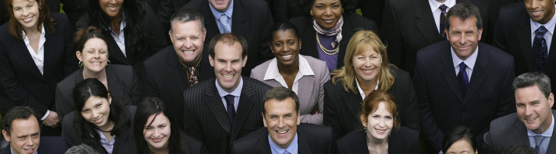 large group of professionals looking up into camera